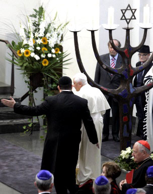Benedict XVI walking by a menorah